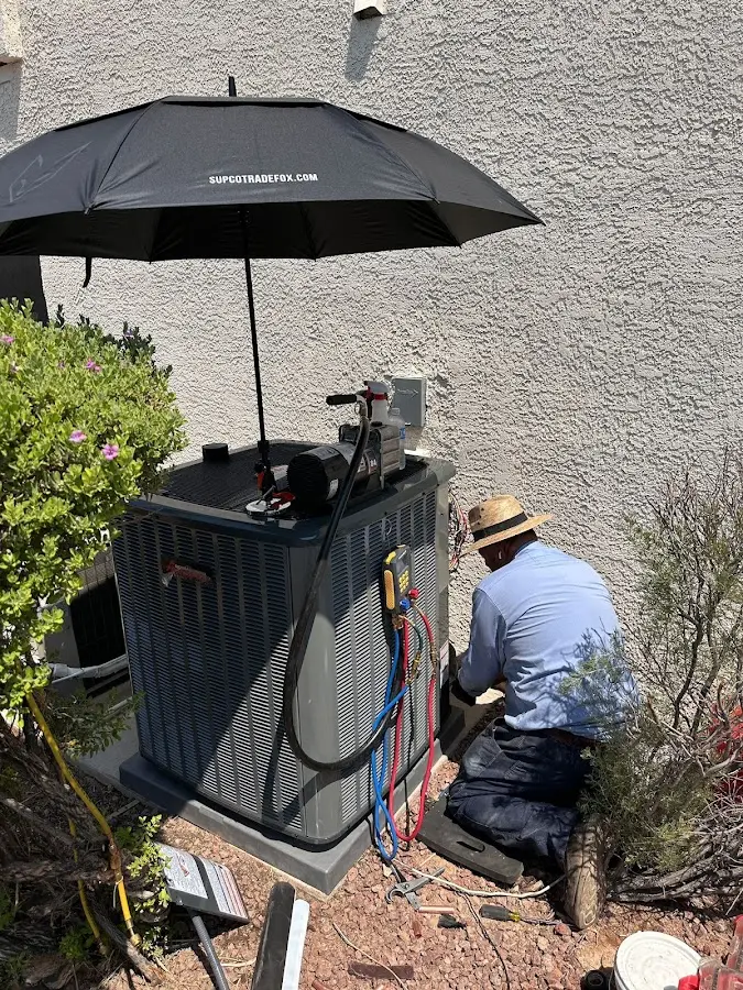 HVAC technician performing outdoor AC maintenance in Winthrop